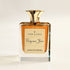 Perfume bottle with gold cap and label on a light background